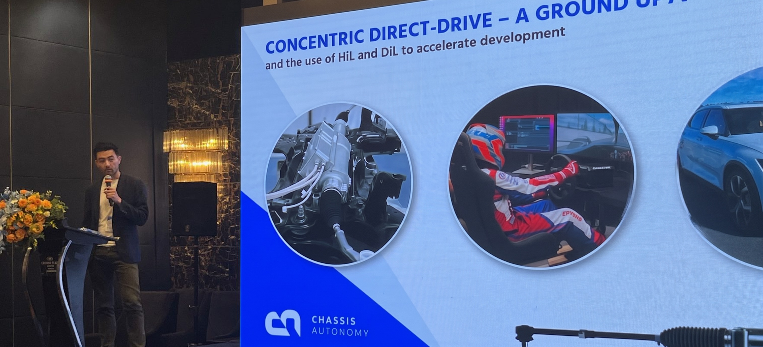 Thomas Li presenting Chassis Autonomy&rsquo;s concentric direct-drive steer-by-wire at a conference in Shanghai